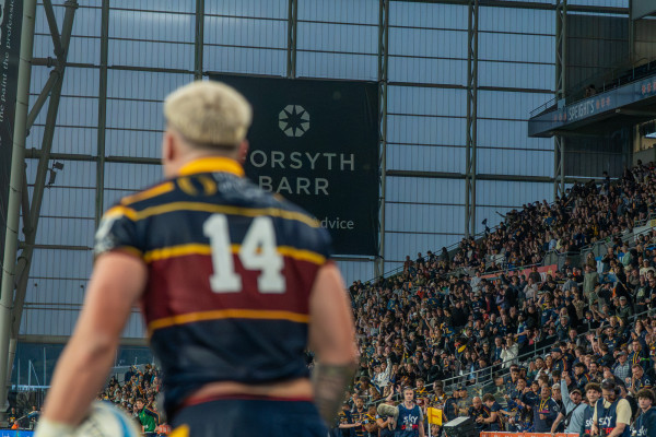 Highlanders player with fans at Forsyth Barr Stadium in Dunedin